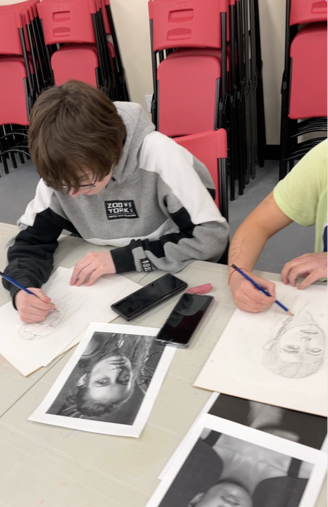 students working on portrait drawings